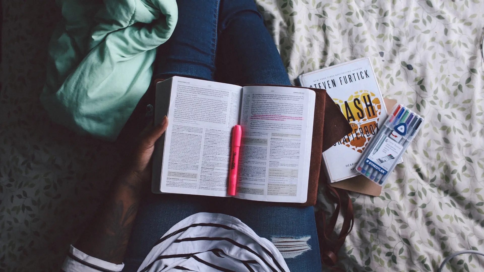 Woman sitting on the floor reading a Bible