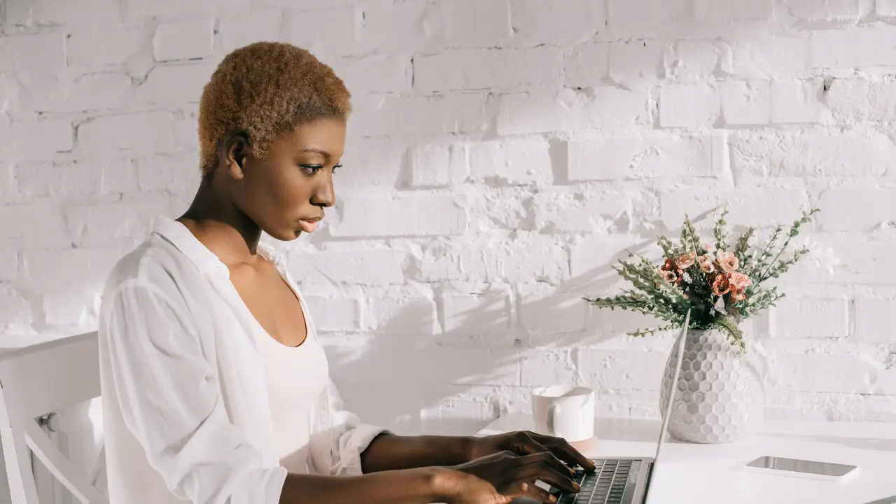 Woman typing on a laptop