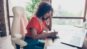 Woman sitting at a desk writing